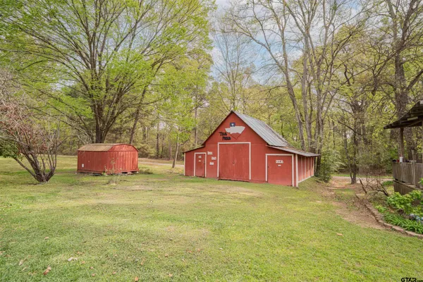 a house with a yard and large trees