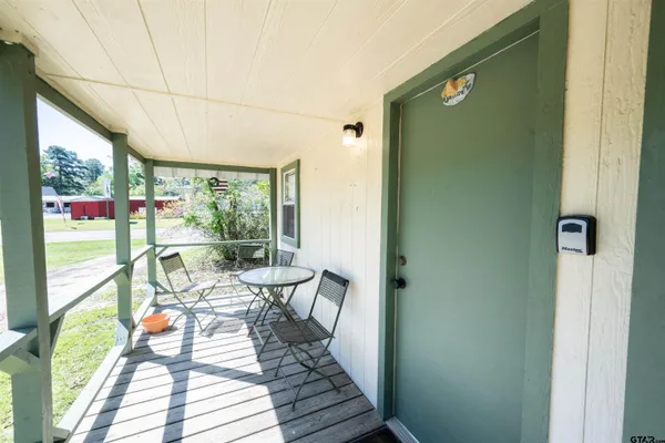 a view of a living room with a large window and furniture