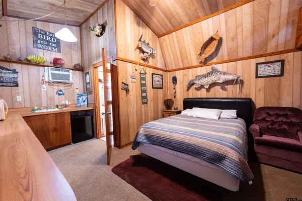 a bedroom with bed and cabinets