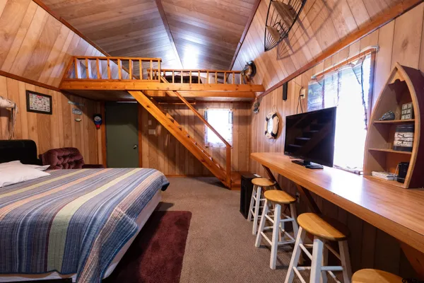 a bedroom with furniture and a flat screen tv