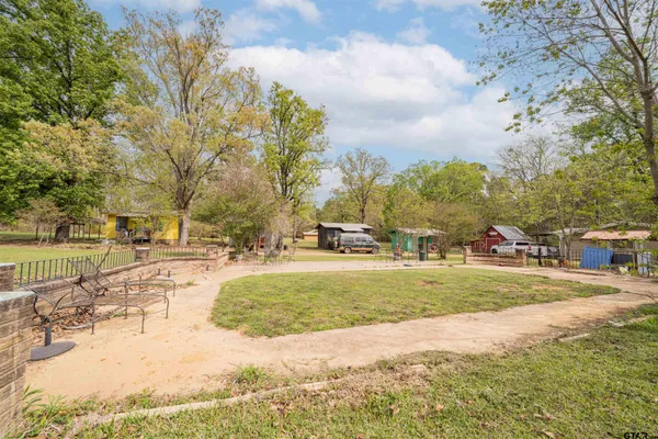 a view of a yard with swimming pool