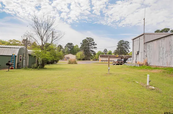 a swimming pool with yard and outdoor seating