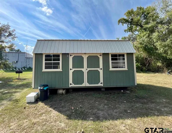 an aerial view of a residential houses with yard