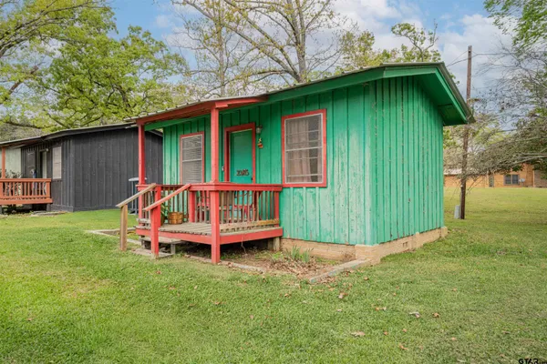 a view of a small house with a small yard