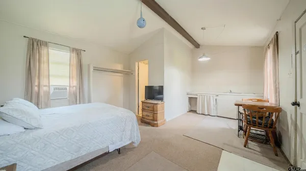 a bedroom with a bed and a table in it