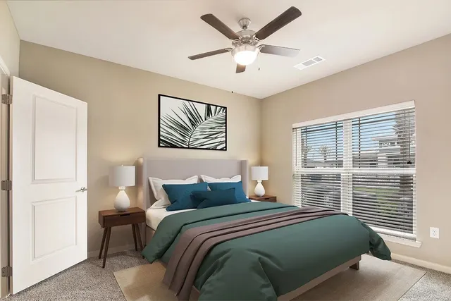 a bedroom with a large bed and a window