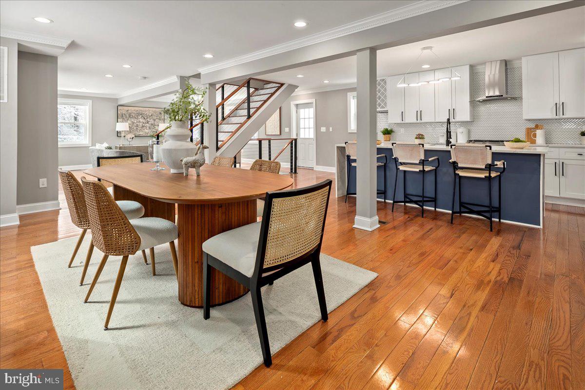 111 Sunnyside Road Silver Spring, MD 20910 - Photo 12 of 44 a dining room with stainless steel appliances kitchen island a table chairs and a kitchen view