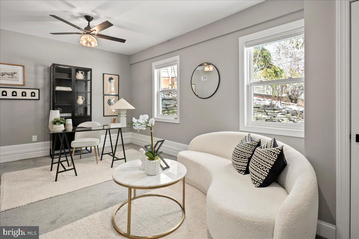 111 Sunnyside Road Silver Spring, MD 20910 - Photo 19 of 44 a living room with furniture a table and a large window