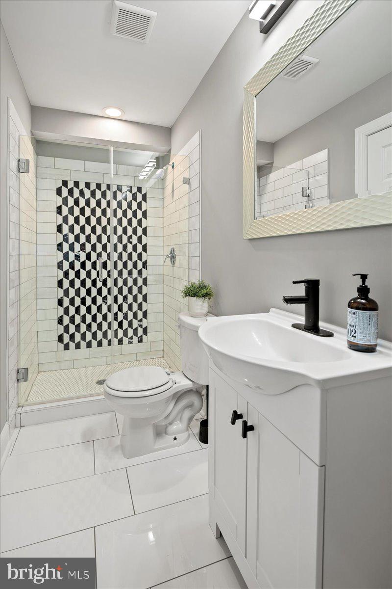 111 Sunnyside Road Silver Spring, MD 20910 - Photo 20 of 44 a bathroom with a sink toilet and shower