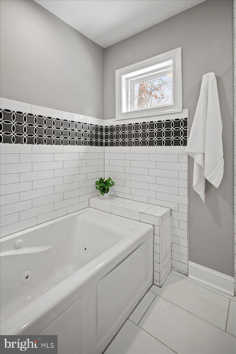 111 Sunnyside Road Silver Spring, MD 20910 - Photo 27 of 44 a bathroom with a bathtub and a shower