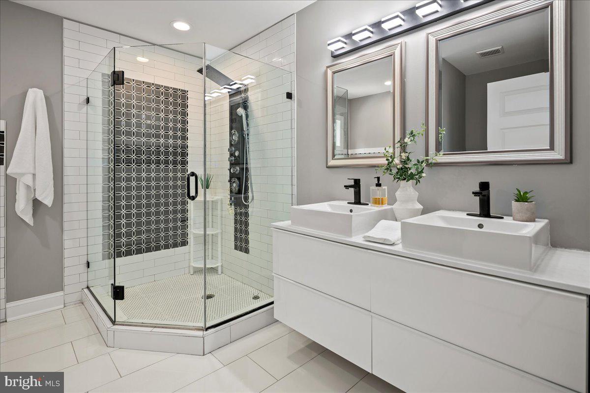 111 Sunnyside Road Silver Spring, MD 20910 - Photo 28 of 44 a bathroom with a shower sink and mirror