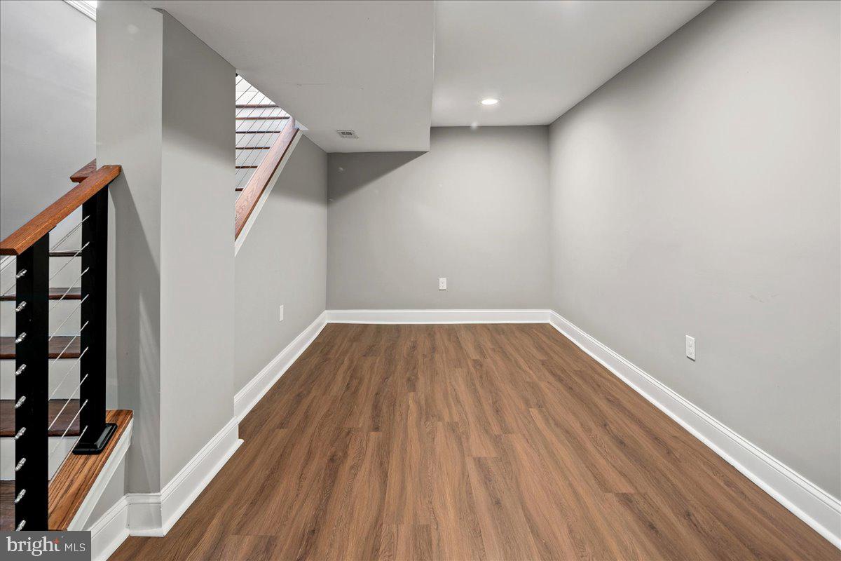111 Sunnyside Road Silver Spring, MD 20910 - Photo 36 of 44 a view of a hallway with wooden floor and staircase