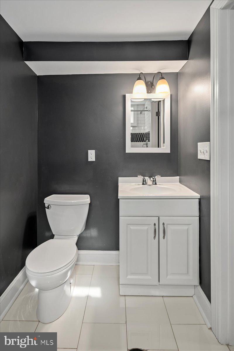 111 Sunnyside Road Silver Spring, MD 20910 - Photo 39 of 44 a bathroom with a toilet sink and mirror