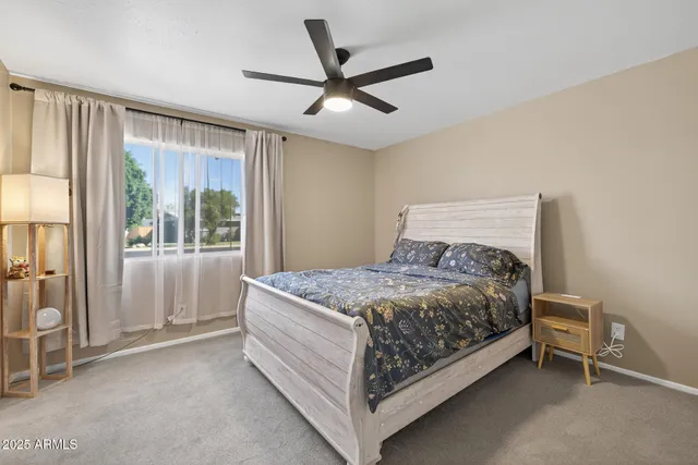 a bed sitting in a room next to a window