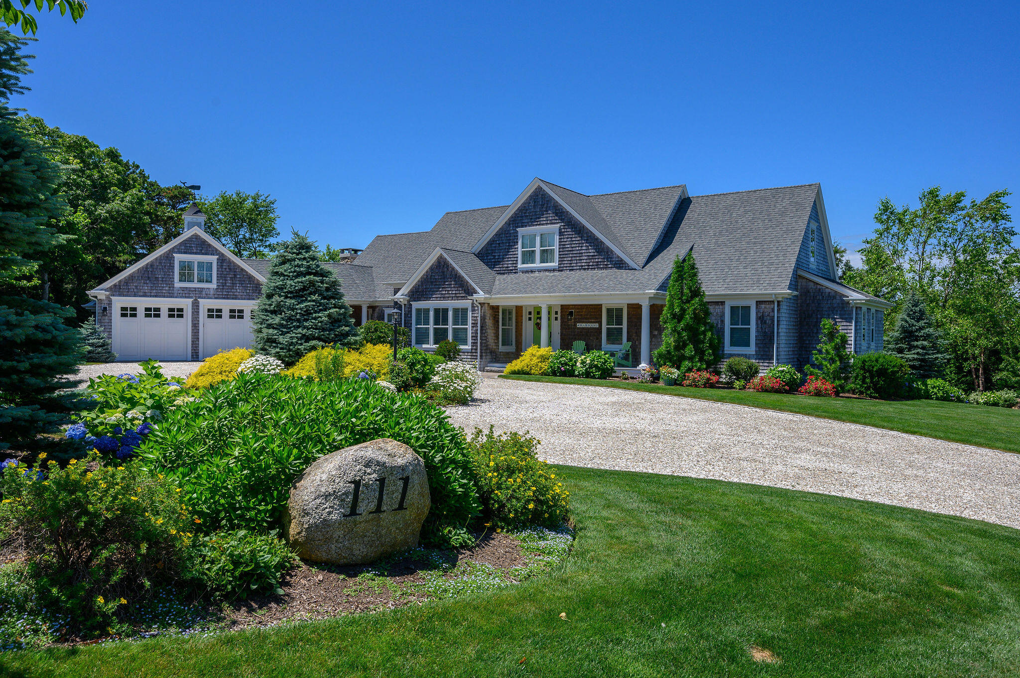 111 Harris Meadow Lane Barnstable, MA 02630 - Photo 2 of 56 a front view of a house with a garden and plants