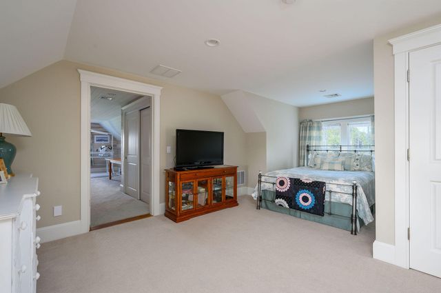 a bedroom with a bed and a television