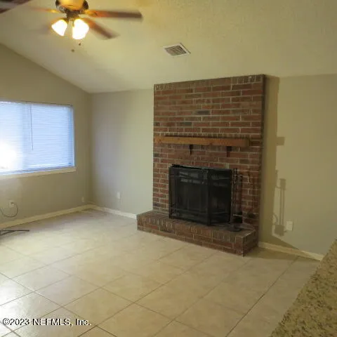 a view of empty room with fireplace