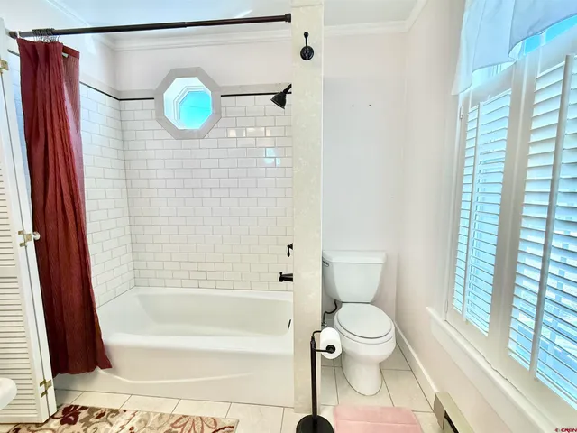 a view of a room with wooden floor and a window