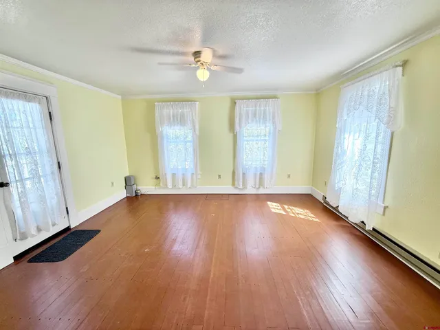 a view of a house with a yard and potted plants