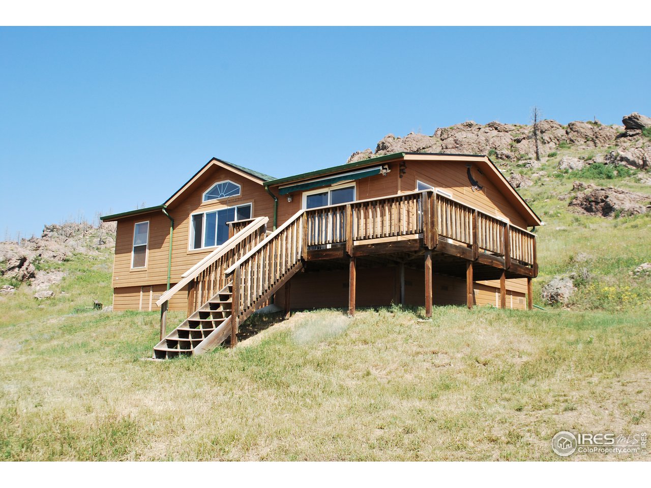 4520 Davis Ranch Road Bellvue, CO 80512 - Photo 1 of 14 a view of a house with a yard