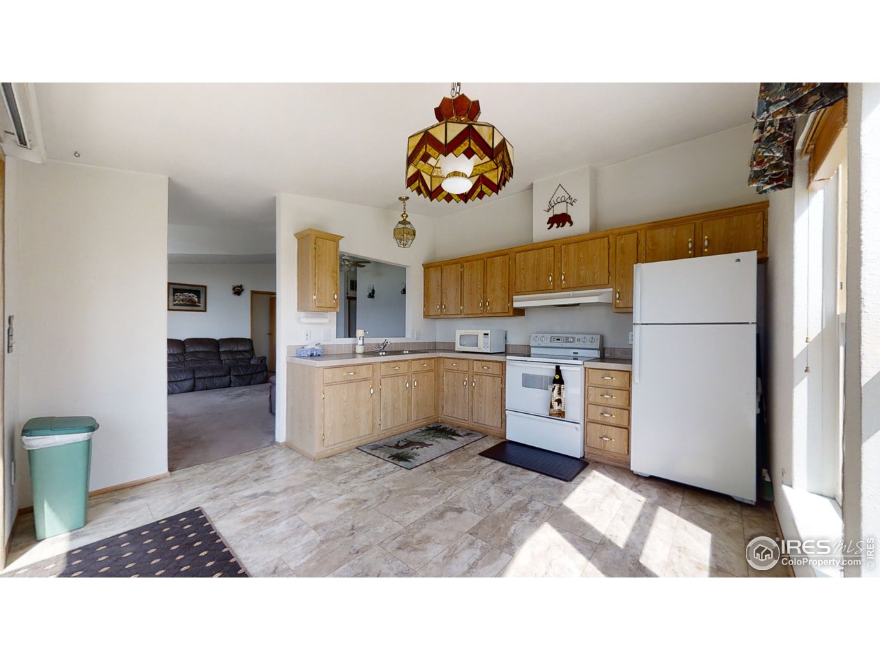 4520 Davis Ranch Road Bellvue, CO 80512 - Photo 11 of 14 a kitchen with a refrigerator a stove top oven a sink and cabinets