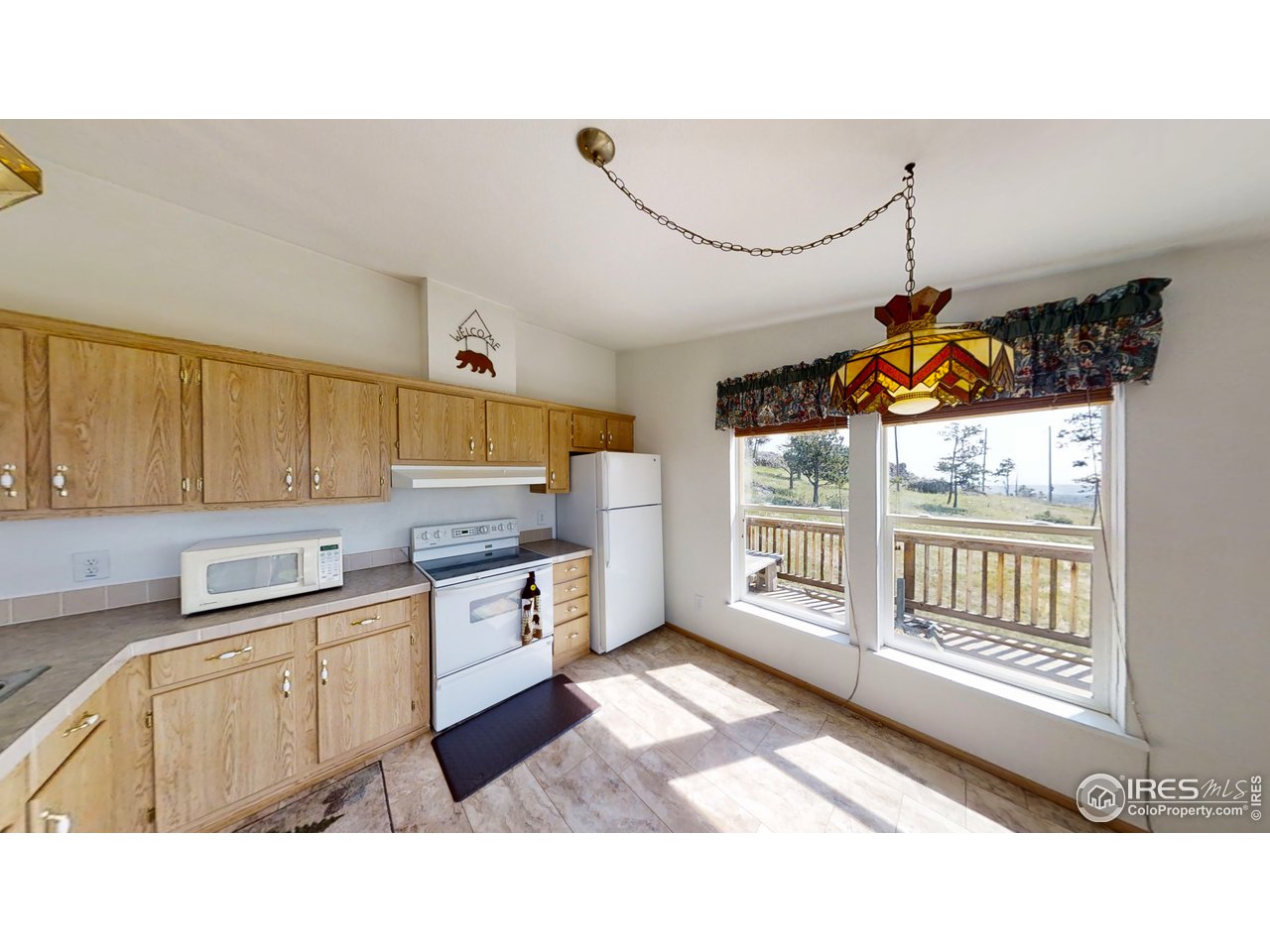 4520 Davis Ranch Road Bellvue, CO 80512 - Photo 14 of 14 a kitchen with granite countertop a sink cabinets and window