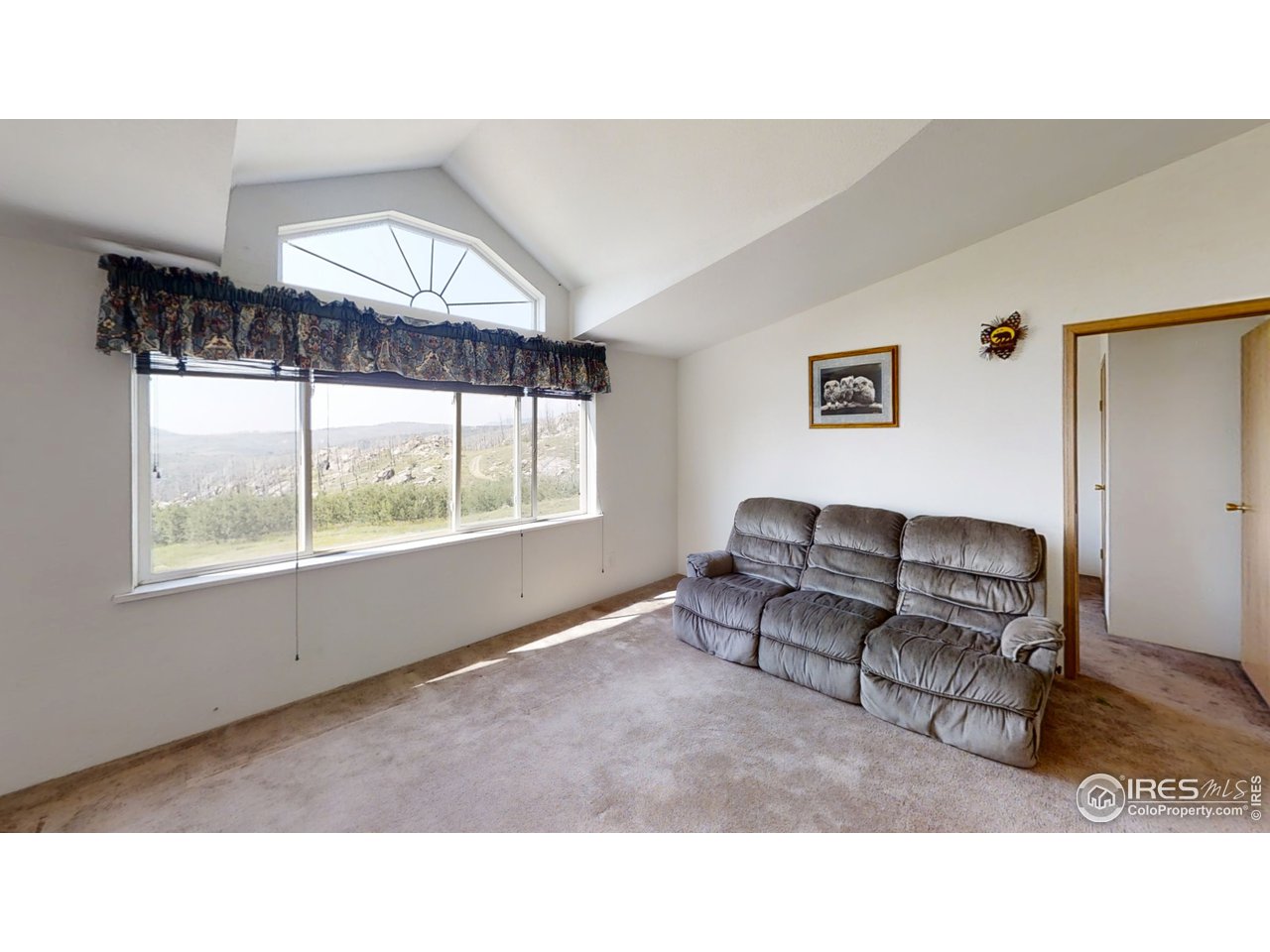 4520 Davis Ranch Road Bellvue, CO 80512 - Photo 10 of 14 a living room with furniture and a large window