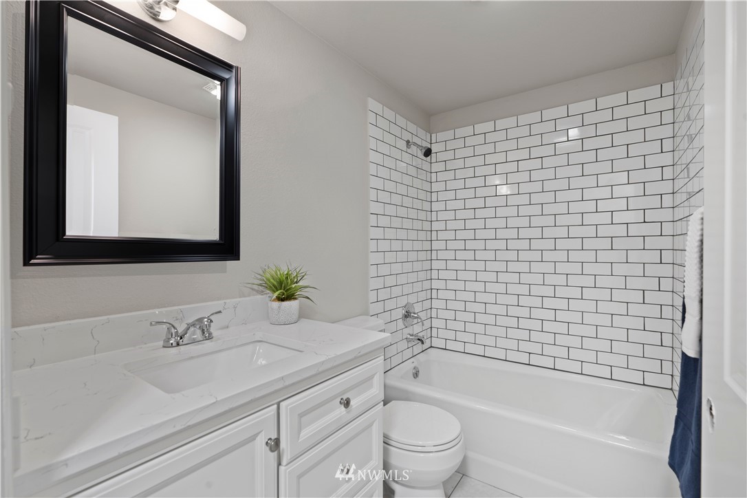17822 Southeast 136th Street Renton, WA 98059 - Photo 14 of 21 a bathroom with a bathtub shower sink vanity and toilet