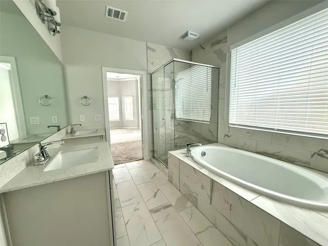 a bathroom with a toilet a sink and bathtub