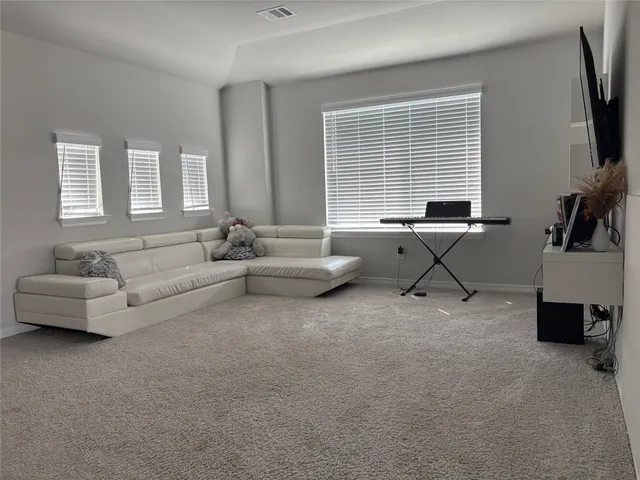 a bathroom with a granite countertop bathtub sink vanity mirror and toilet