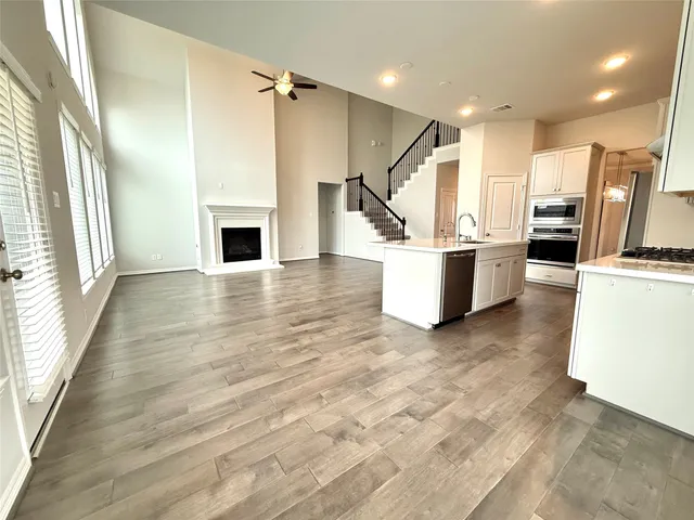 an empty room with wooden floor and fireplace
