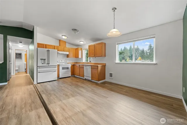 a kitchen with stainless steel appliances granite countertop a stove a sink dishwasher and a refrigerator