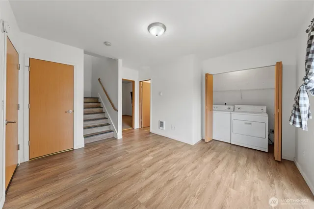 a view of a kitchen with wooden floor and electronic appliances