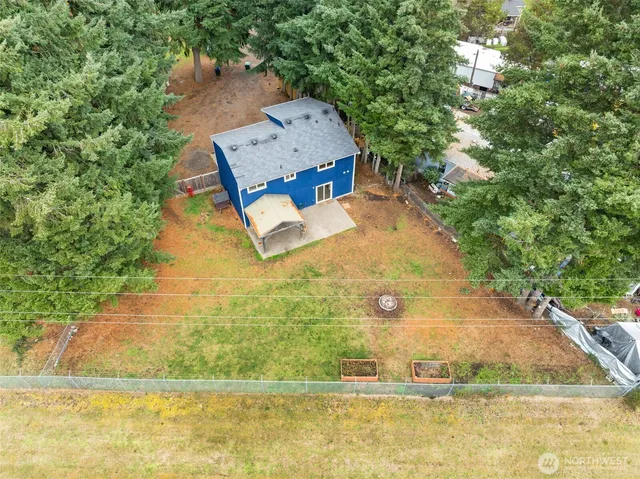 an aerial view of a house with pool yard and outdoor seating
