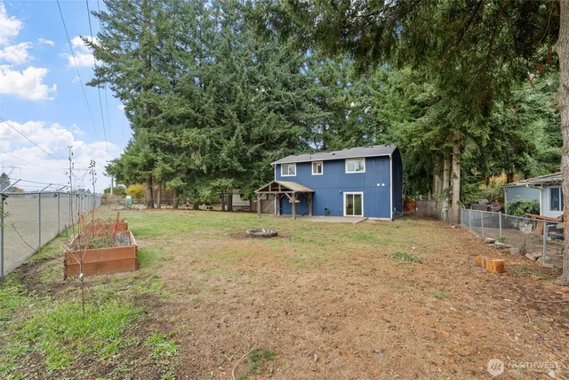 a front view of a house with a yard and trees