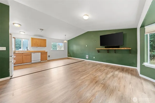 a view of a livingroom with wooden floor and a flat screen tv