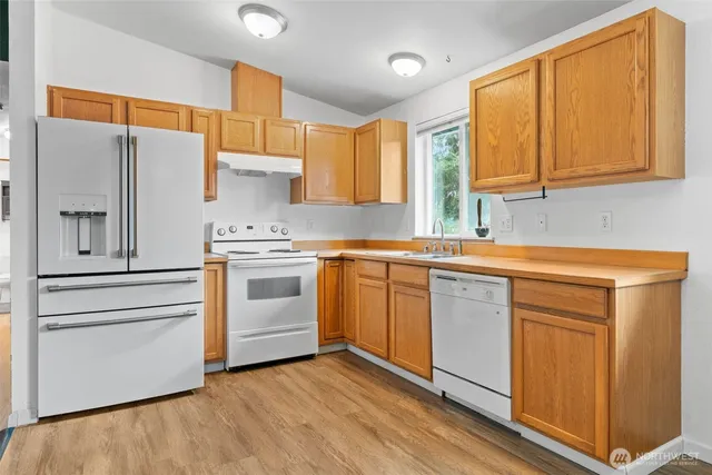 a kitchen with stainless steel appliances white cabinets and a sink