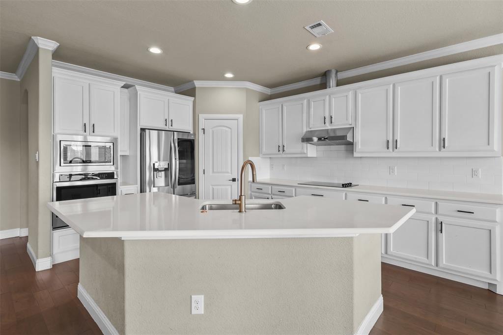 2451 Neck Road Palmer, TX 75152 - Photo 13 of 32 a large kitchen with kitchen island a sink a center island stainless steel appliances and cabinets