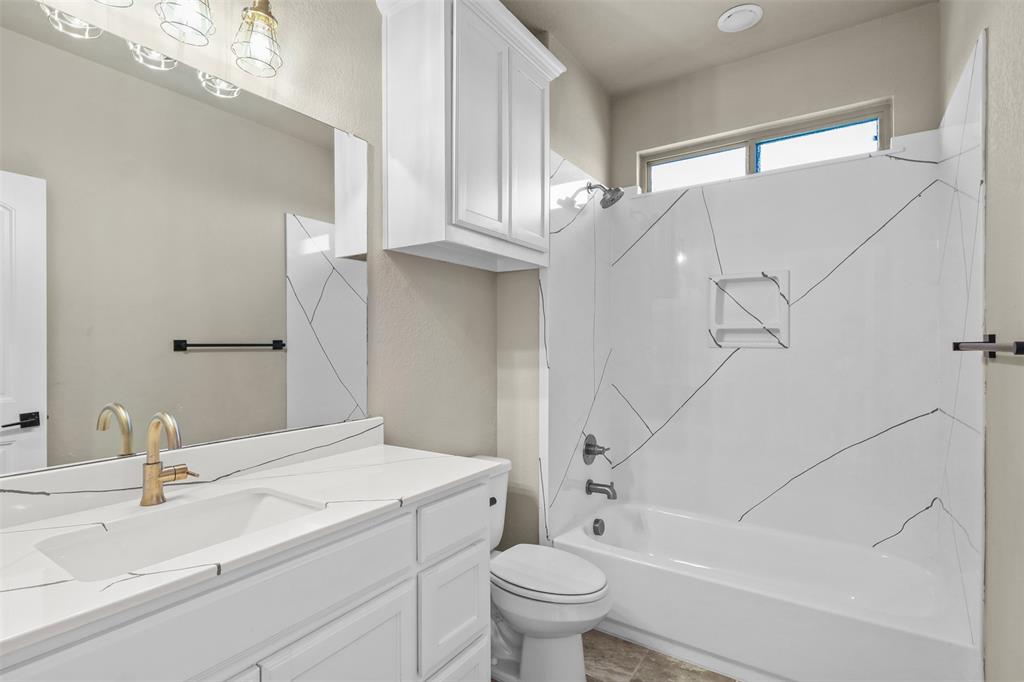 2451 Neck Road Palmer, TX 75152 - Photo 25 of 32 a bathroom with a sink a toilet and shower