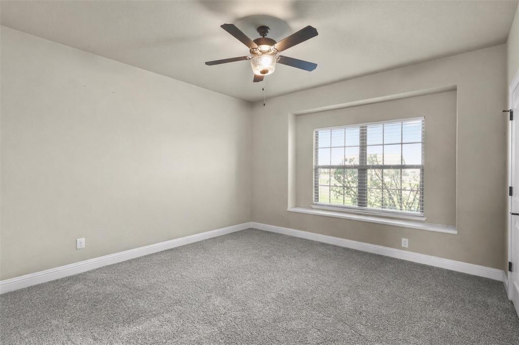 2451 Neck Road Palmer, TX 75152 - Photo 26 of 32 an empty room with windows and ceiling fan