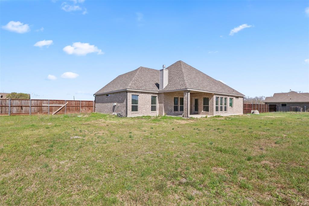 2451 Neck Road Palmer, TX 75152 - Photo 32 of 32 a front view of a house with a garden
