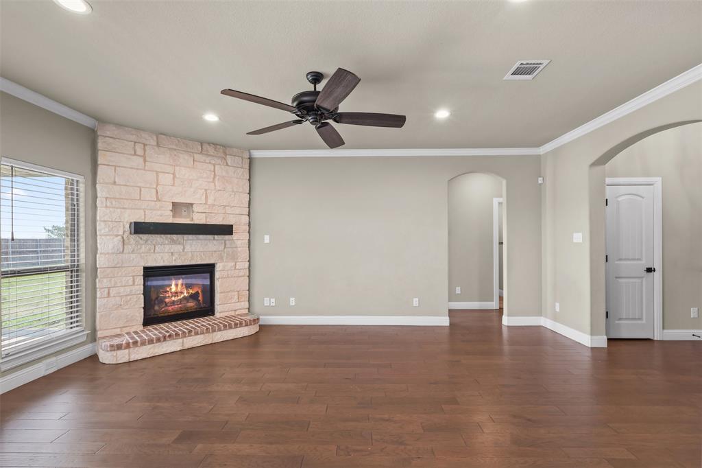 2451 Neck Road Palmer, TX 75152 - Photo 7 of 32 a view of an empty room with a fireplace and window