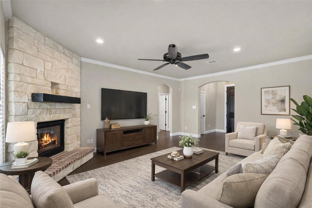 2451 Neck Road Palmer, TX 75152 - Photo 9 of 32 a living room with furniture flat screen tv and a fireplace