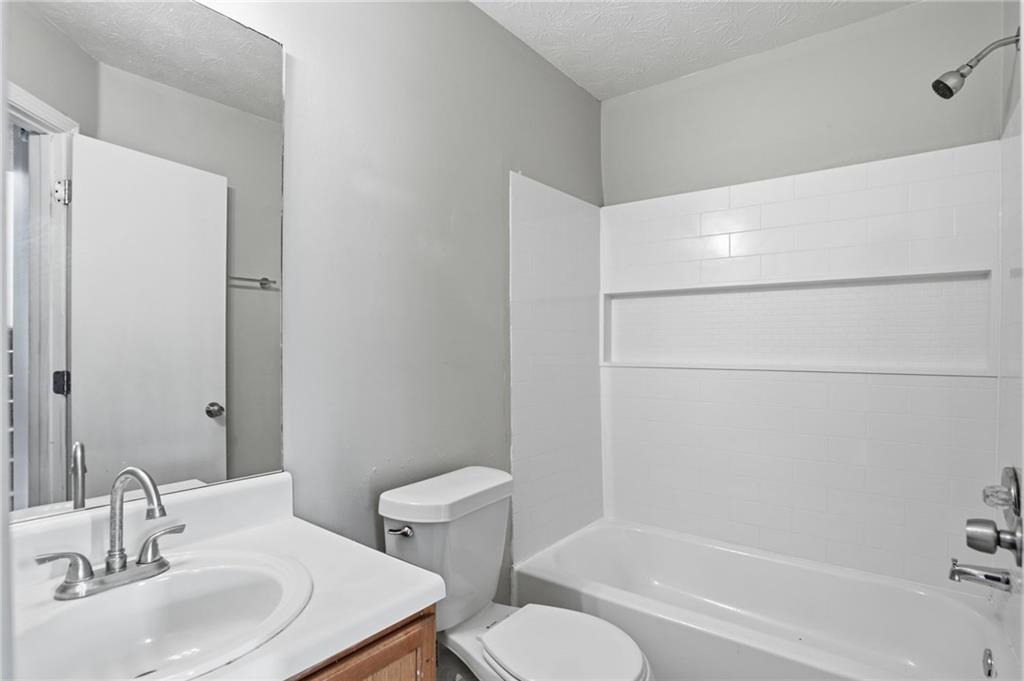 5855 Crescent Ridge Court Lithonia, GA 30058 - Photo 35 of 46 a bathroom with a sink toilet and shower