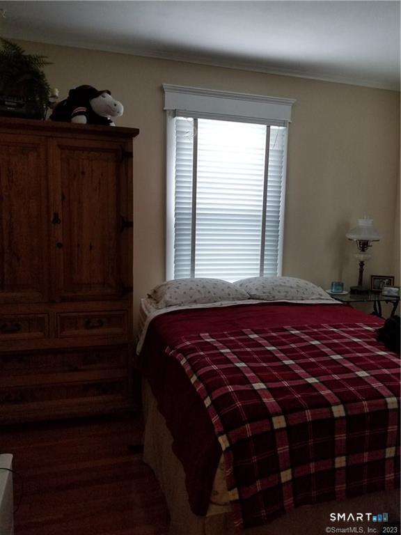 26 4th Street Hamden, CT 06514 - Photo 4 of 40 a bed sitting in a bedroom next to a window