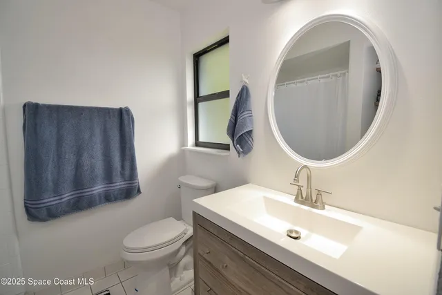 a bathroom with a sink mirror and toilet