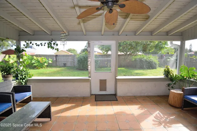 a front view of a house with a garden and trees