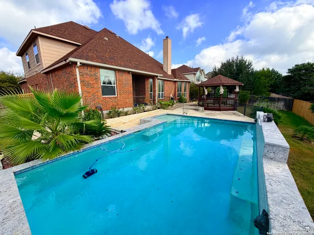 a view of a house with pool porch and sitting area
