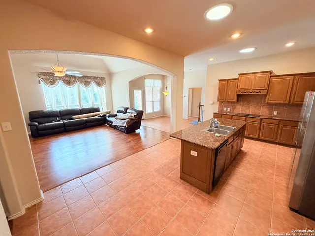 a kitchen with stainless steel appliances granite countertop a stove and a sink