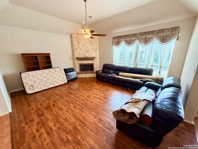 a bedroom with furniture and a wooden floor